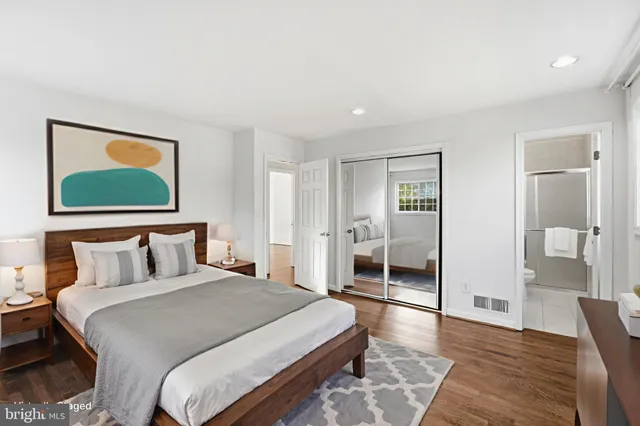 a bedroom with a bed and a painting on the wall