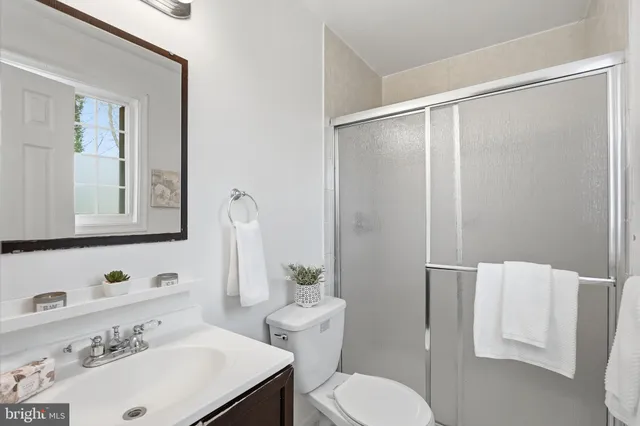 a bathroom with a sink toilet and mirror