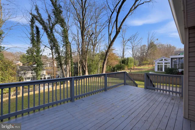 a view of a balcony with wooden floor and fence