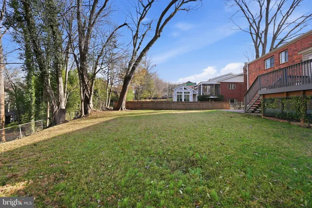a view of a yard with a house and large trees