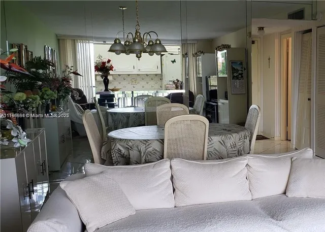 a dining room with furniture and a potted plant