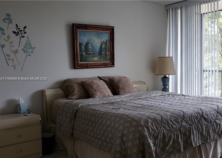 3821 Environ Boulevard, Unit 406 Lauderhill, FL 33319 - Photo 14 of 23 a bed sitting in a bedroom next to a window