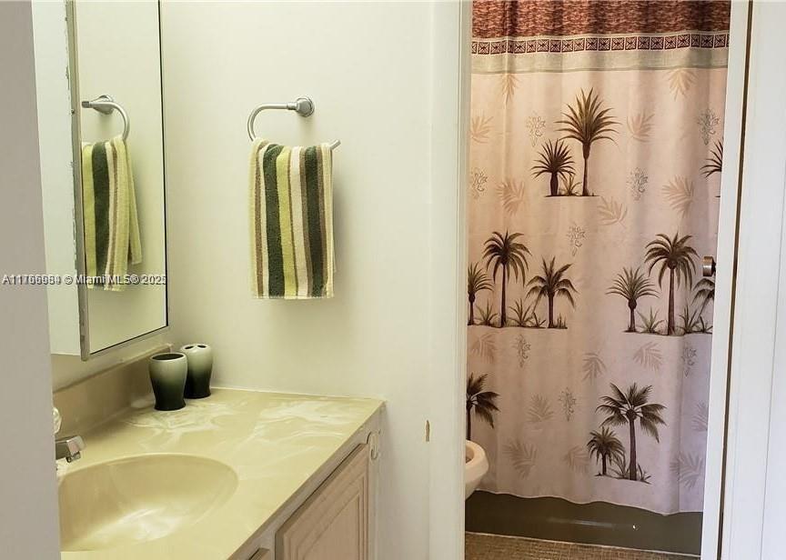 3821 Environ Boulevard, Unit 406 Lauderhill, FL 33319 - Photo 15 of 23 a bathroom with a granite countertop sink a mirror and a shower