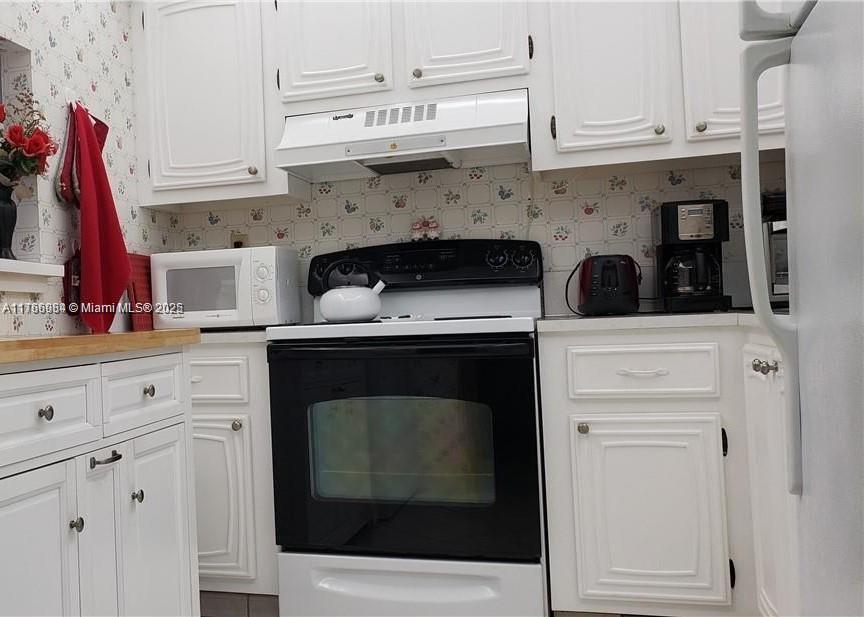 3821 Environ Boulevard, Unit 406 Lauderhill, FL 33319 - Photo 5 of 23 a stove top oven sitting inside of a kitchen