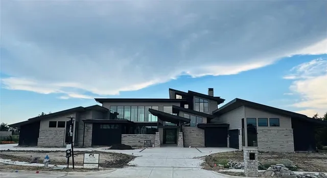 a front view of a house with plants