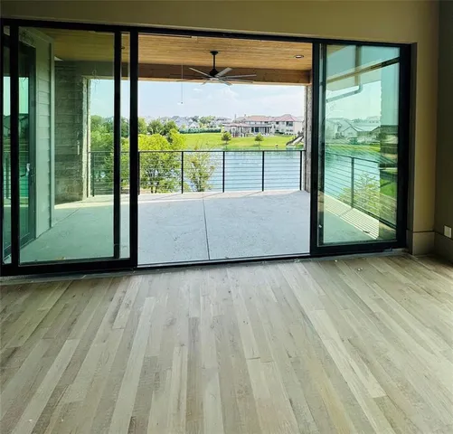a view of a room with wooden floor and iron stairs