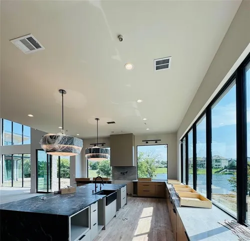 a view of a kitchen with granite countertop a large window