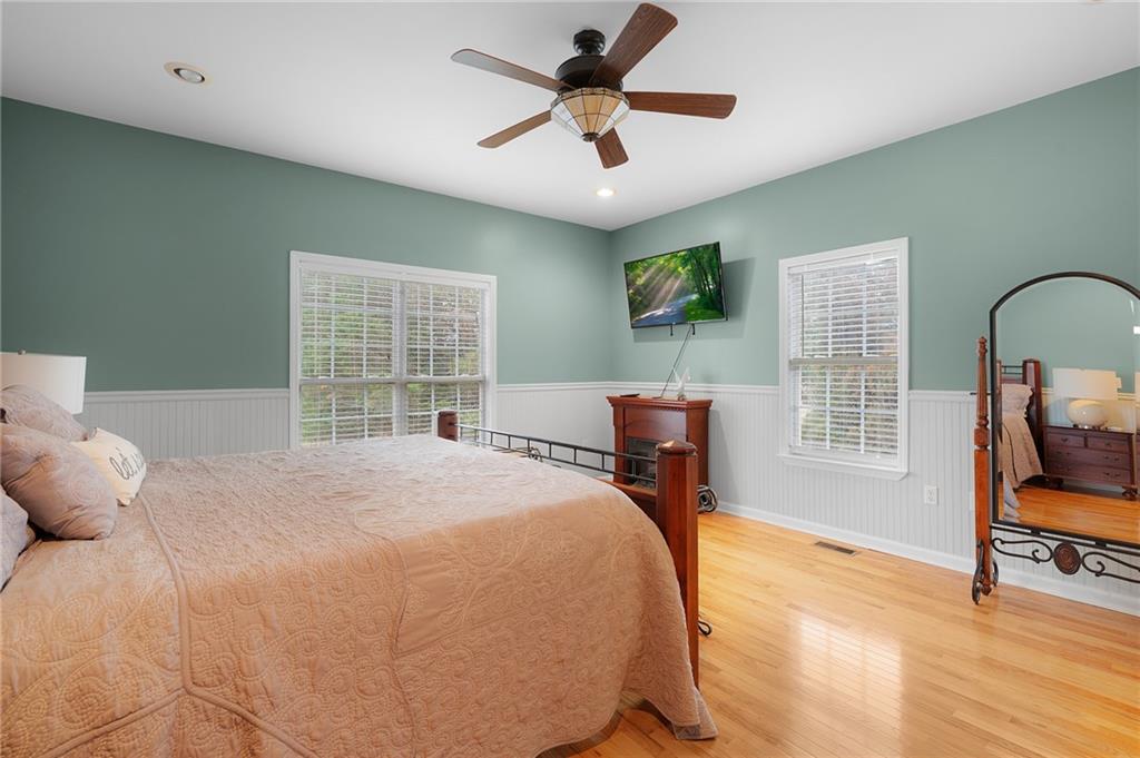 425 McDaniel Station Road Southwest Calhoun, GA 30701 - Photo 16 of 46 a bedroom with a bed a dresser and a chandelier