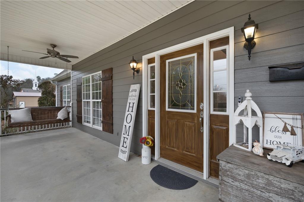 425 McDaniel Station Road Southwest Calhoun, GA 30701 - Photo 2 of 46 a view of a porch with a table and chairs