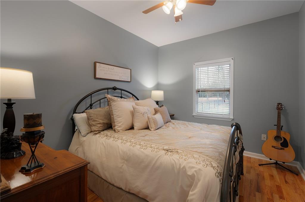 425 McDaniel Station Road Southwest Calhoun, GA 30701 - Photo 24 of 46 a bedroom with a bed and a chandelier