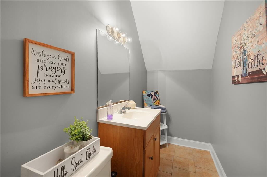 425 McDaniel Station Road Southwest Calhoun, GA 30701 - Photo 30 of 46 a bathroom with a sink mirror and vanity