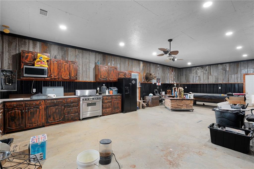 425 McDaniel Station Road Southwest Calhoun, GA 30701 - Photo 38 of 46 a kitchen with lots of counter top space cabinets and stainless steel appliances