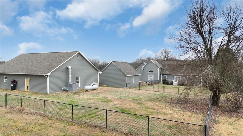 425 McDaniel Station Road Southwest Calhoun, GA 30701 - Photo 39 of 46 a view of a white house next to a yard with large tree