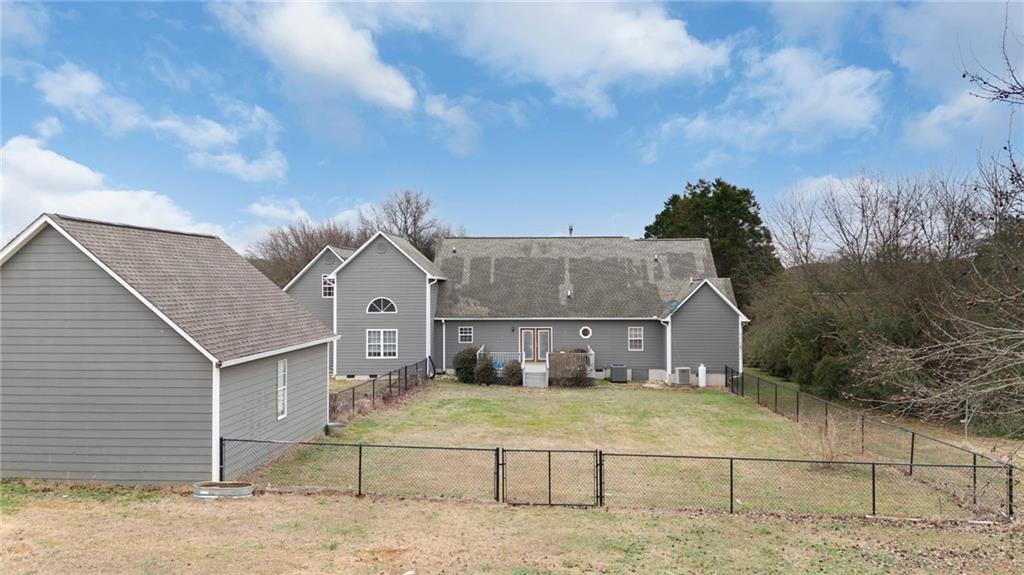 425 McDaniel Station Road Southwest Calhoun, GA 30701 - Photo 40 of 46 a view of a white house next to a yard with big trees