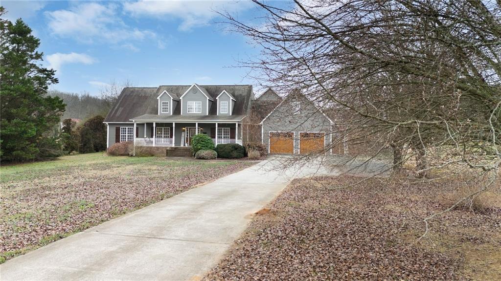 425 McDaniel Station Road Southwest Calhoun, GA 30701 - Photo 42 of 46 a front view of a house with a garden
