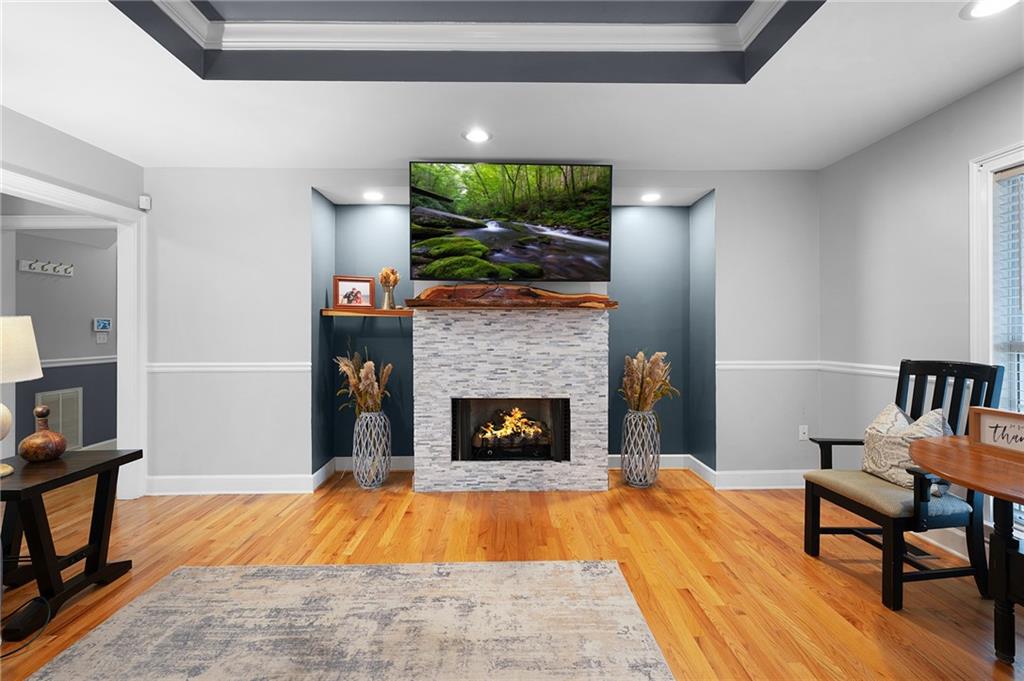 425 McDaniel Station Road Southwest Calhoun, GA 30701 - Photo 7 of 46 a living room with a flat screen tv and a fireplace