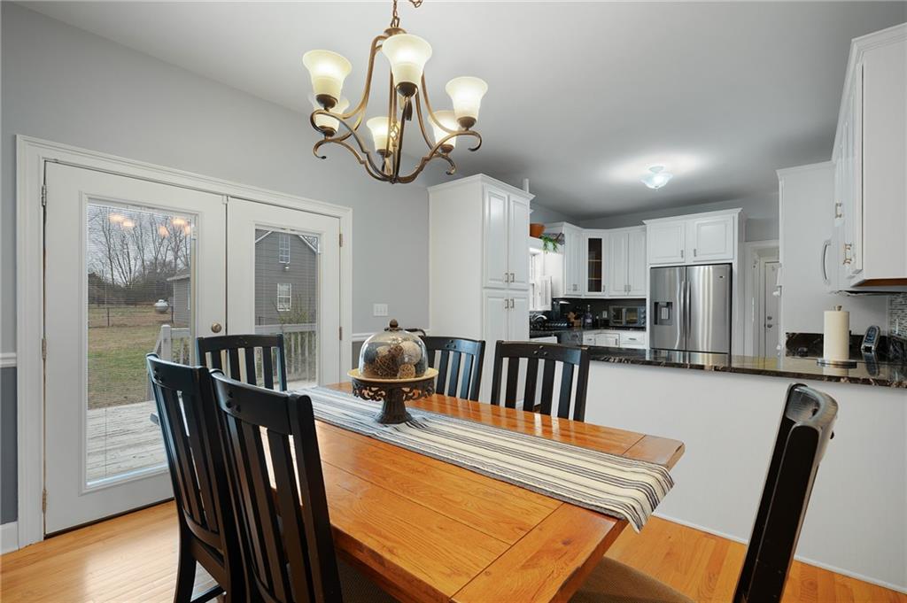 425 McDaniel Station Road Southwest Calhoun, GA 30701 - Photo 9 of 46 a view of a dining room with furniture wooden floor and chandelier