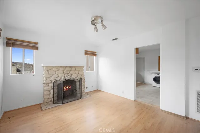 a view of empty room with a fireplace