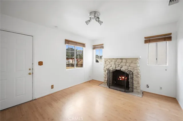 a view of an empty room with a fireplace