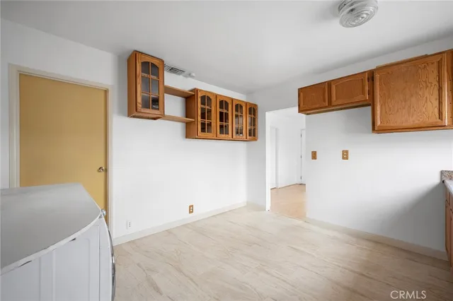 a view of a livingroom with wooden floor and cabinet