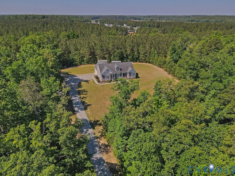 9425 Marie Road New Kent, VA 23124 - Photo 1 of 55 a view of a lake with a building in the background