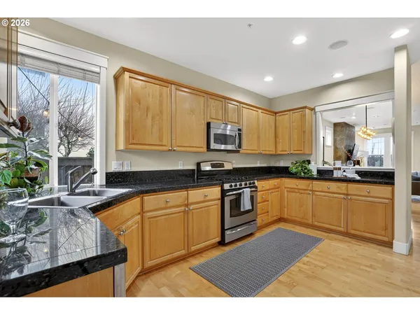 a kitchen with stainless steel appliances granite countertop a refrigerator and a sink