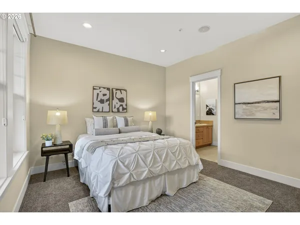 a bedroom with a bed and a large window