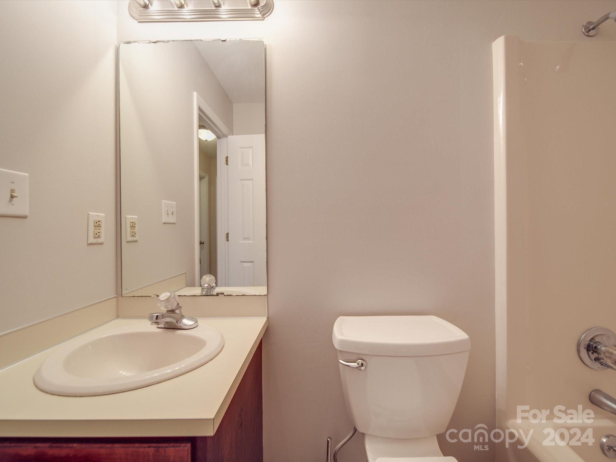 3806 Dusty Hollow Road Monroe, NC 28110 - Photo 12 of 21 a bathroom with a sink a toilet and mirror