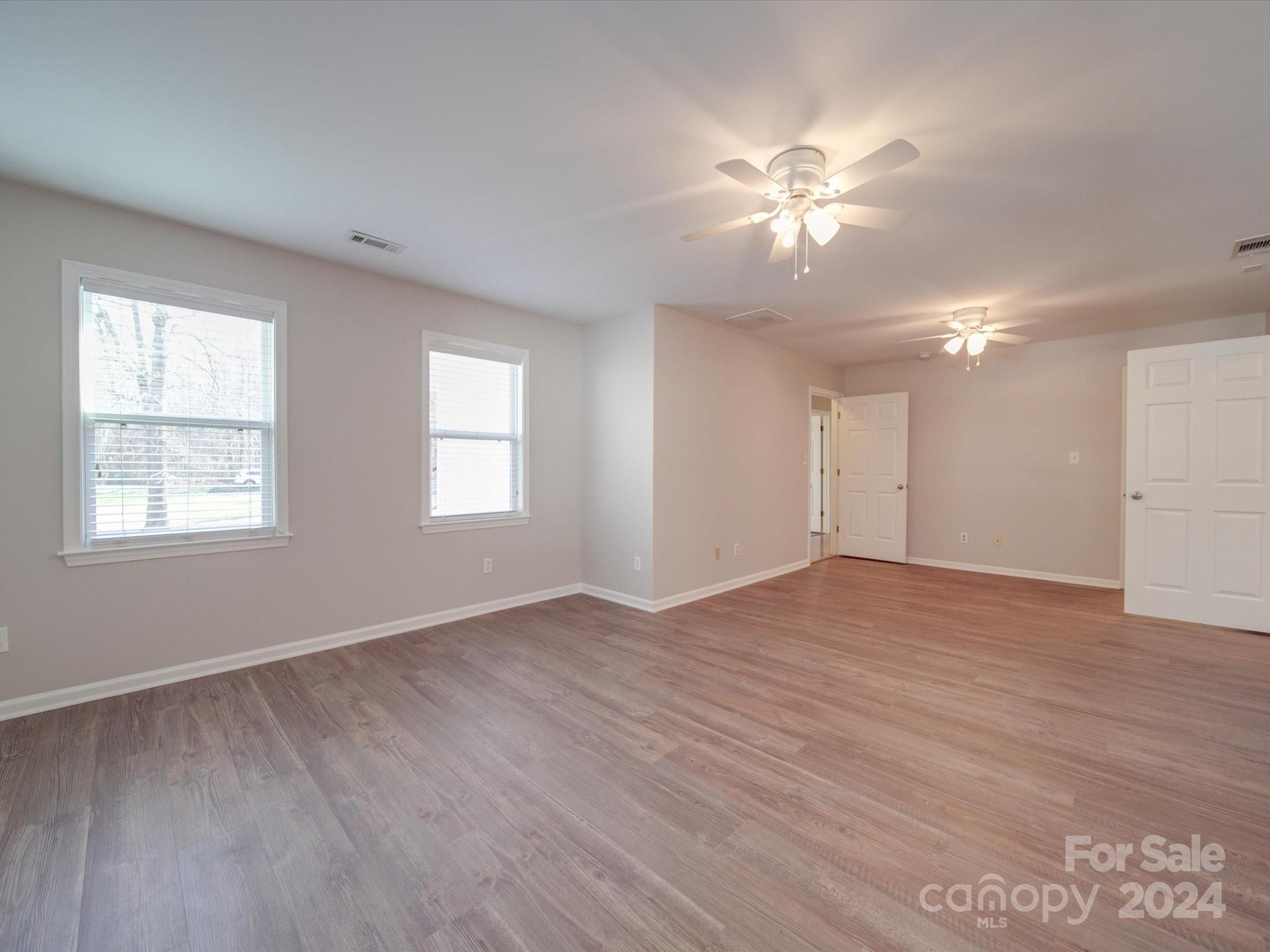 3806 Dusty Hollow Road Monroe, NC 28110 - Photo 13 of 21 a view of an empty room with wooden floor and a window