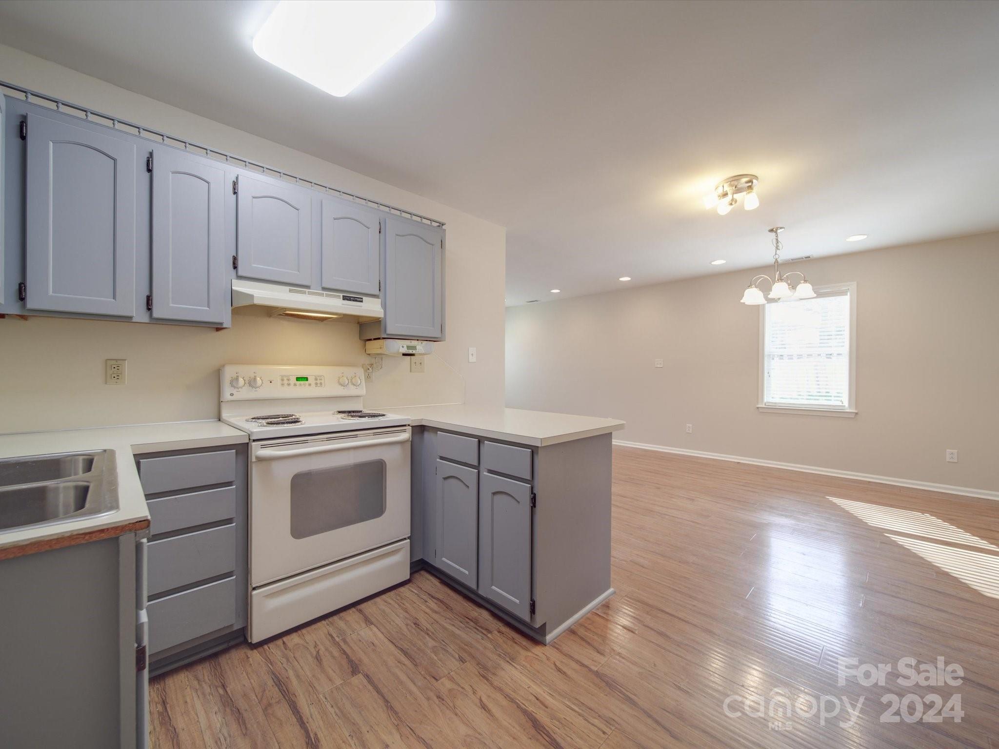 3806 Dusty Hollow Road Monroe, NC 28110 - Photo 16 of 21 a kitchen with stainless steel appliances granite countertop a stove a sink and a refrigerator