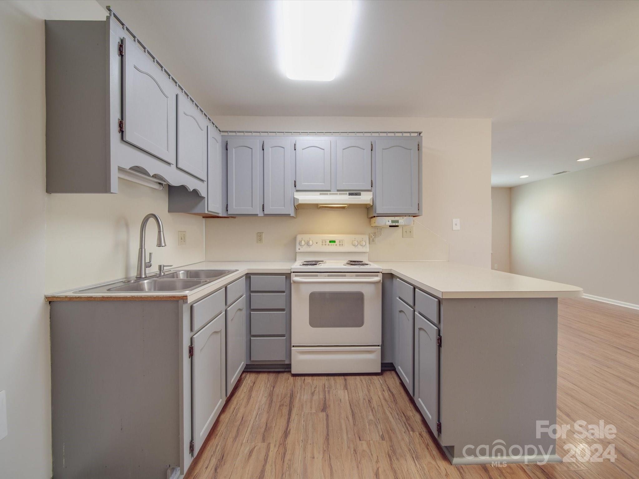 3806 Dusty Hollow Road Monroe, NC 28110 - Photo 20 of 21 a kitchen with a sink a stove and cabinets