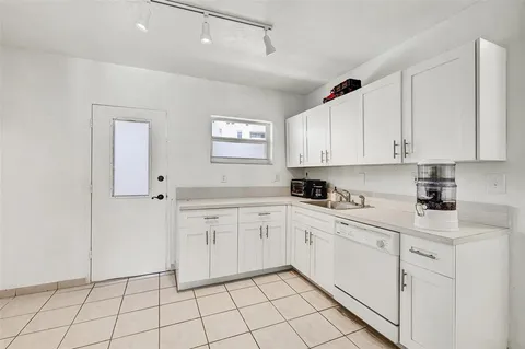 a kitchen with white cabinets