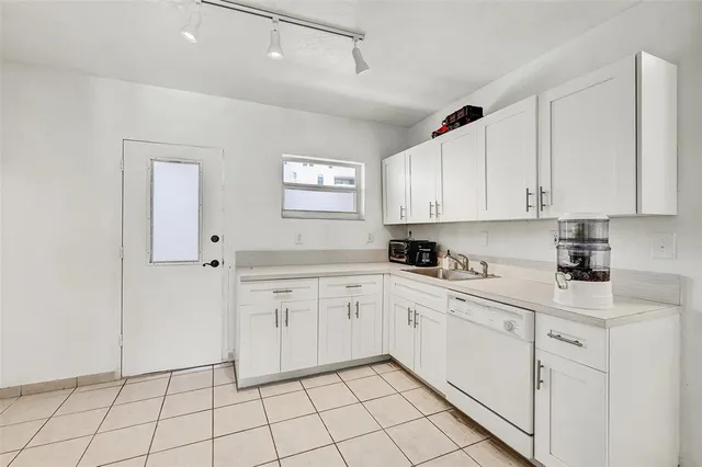 a kitchen with white cabinets