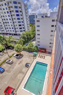 a white house with a yard and furniture