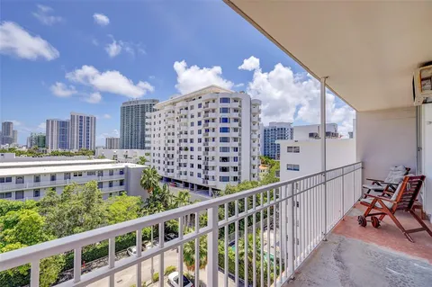 a view of a balcony with wooden benches