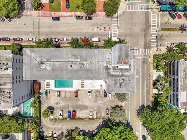 an aerial view of residential houses with outdoor space and parking