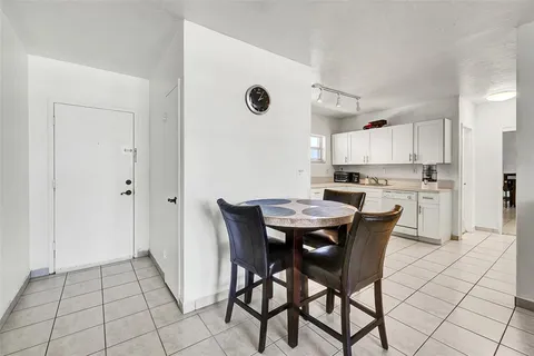 a view of kitchen with refrigerator dining table and chairs
