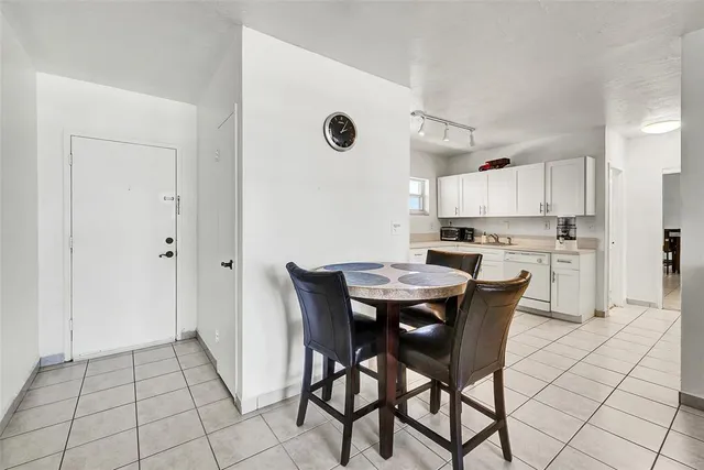 a view of kitchen with refrigerator dining table and chairs