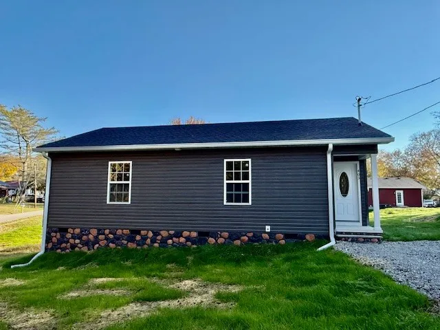a front view of a house with a garden