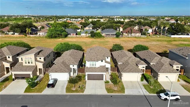 an aerial view of residential houses with outdoor space