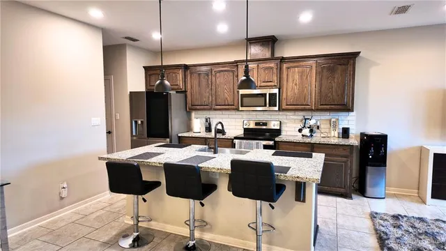 a kitchen with a chandelier dining table and chairs