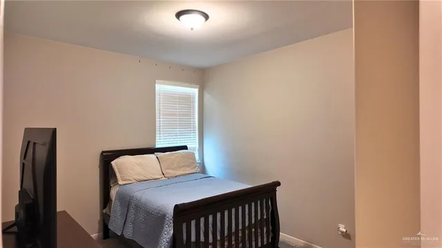 a bedroom with a bed and window