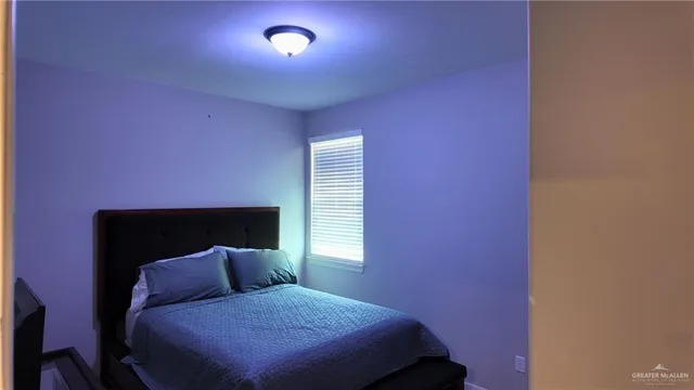 a bed room with a bed and a window