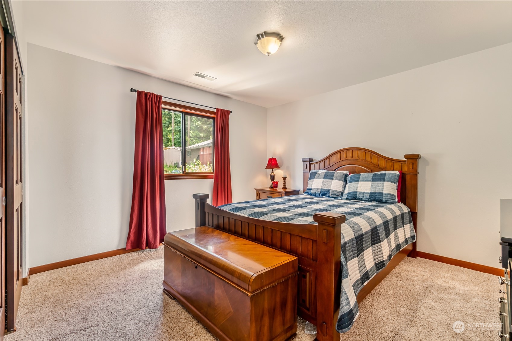 15333 West Lake Goodwin Road Stanwood, WA 98292 - Photo 23 of 39 a bed sitting in a bedroom next to a window