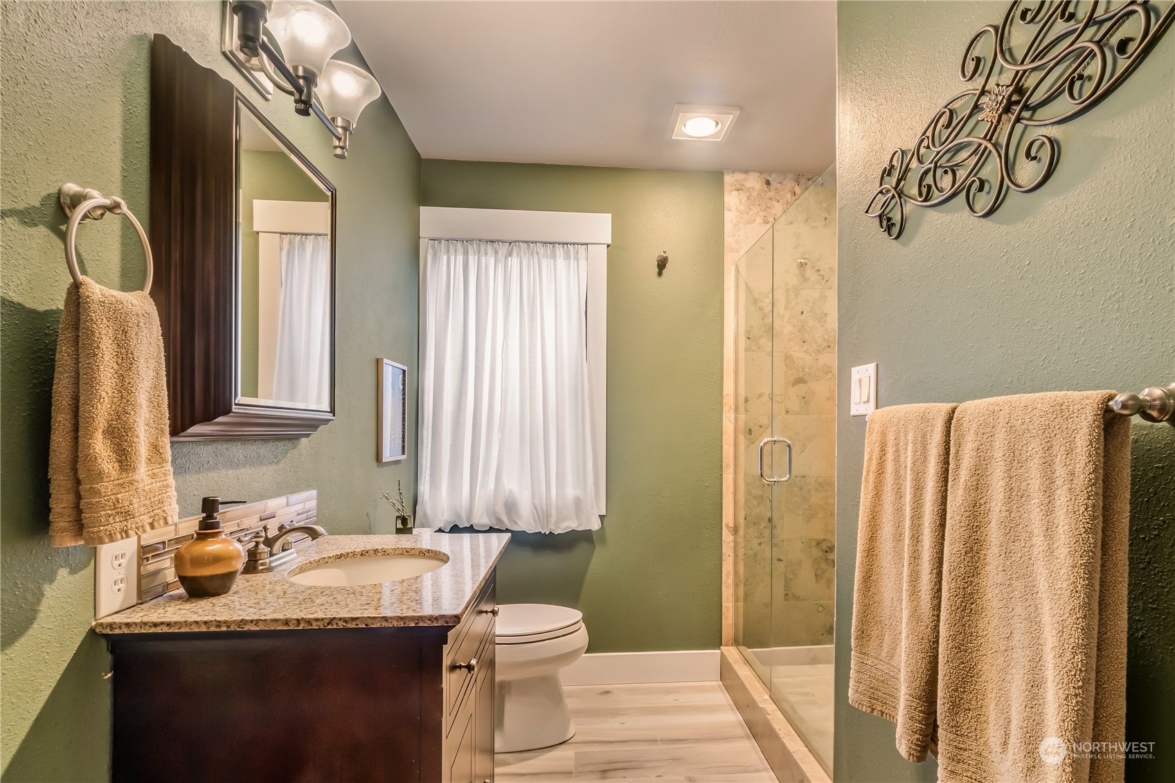 15333 West Lake Goodwin Road Stanwood, WA 98292 - Photo 24 of 39 a bathroom with a sink a toilet and mirror