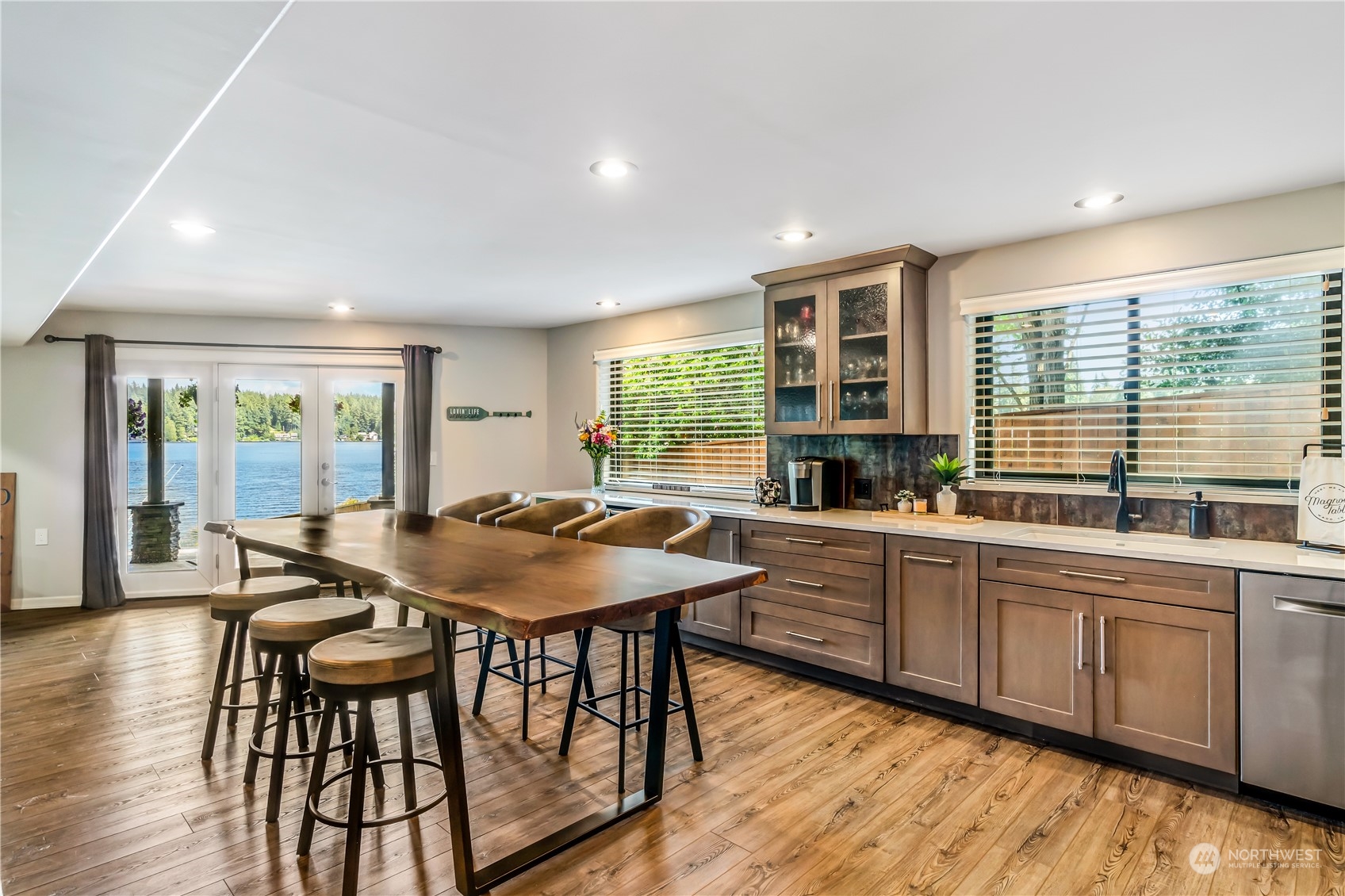 15333 West Lake Goodwin Road Stanwood, WA 98292 - Photo 30 of 39 a kitchen with a table chairs sink and wooden floor