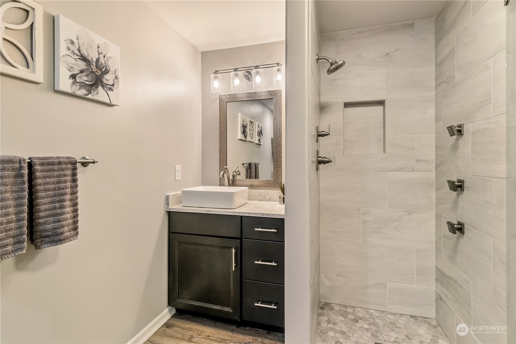 15333 West Lake Goodwin Road Stanwood, WA 98292 - Photo 35 of 39 a bathroom with a sink a mirror a glass door and shower