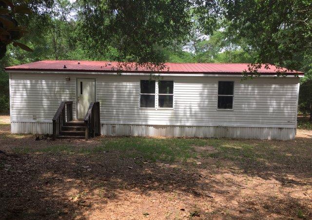6146 Lake Ella Road Crestview, FL 32539 - Photo 11 of 12 a backyard of a house with barbeque oven and outdoor seating