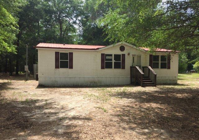 6146 Lake Ella Road Crestview, FL 32539 - Photo 3 of 12 a front view of a house with a yard