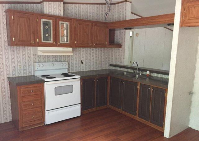 6146 Lake Ella Road Crestview, FL 32539 - Photo 4 of 12 a kitchen with a sink stove and cabinets